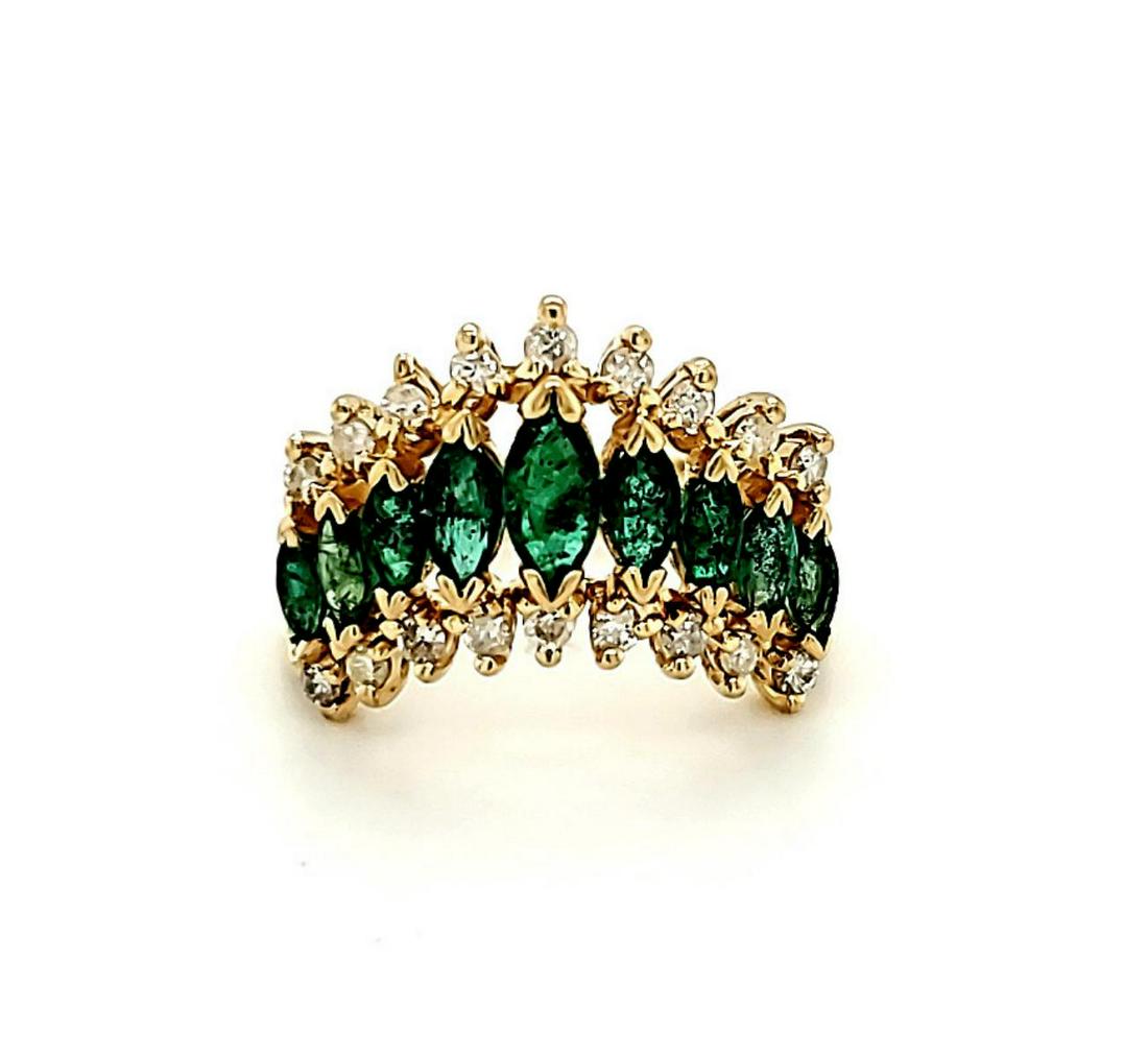 14kt yellow gold emerald and diamond ring: Ladies 14kt yellow gold emerald and diamond ring featuring a center row of prong set marquise cut emeralds weighing approx. 0.70ct. and accented with outer rows of prong set round diamonds weighing ap