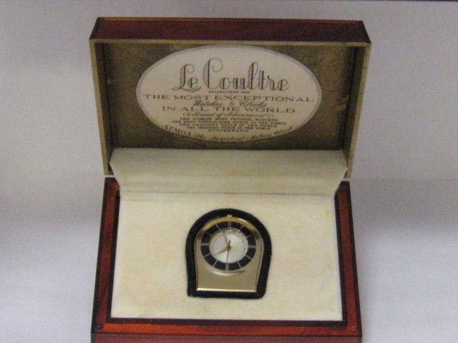 Jaeger-LeCoultre alarm watch: Jaeger-LeCoultre Memovox purse pocket alarm watch with gold tone case and enameling. Hinged lid reverses to form an easel stand with manual wind Memovox movement. Comes with original box and papers.