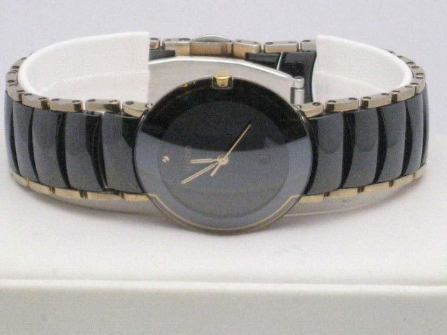 Rado Diaster ceramic Swiss watch: Rado Diastar watch with black ceramic case and gold accent links, date window,swiss movement,sapphire crystal, box and papers.
