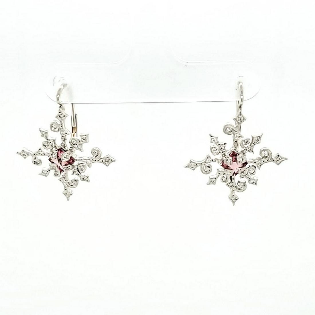 14kt white gold Cathy Waterman earrings: 14kt white gold earrings by designer Cathy Waterman, featuring a scrolling snowflake design accented with prong set round diamonds 0.24ct, and accented with square cut pink sapphires measures 4x4mm. L