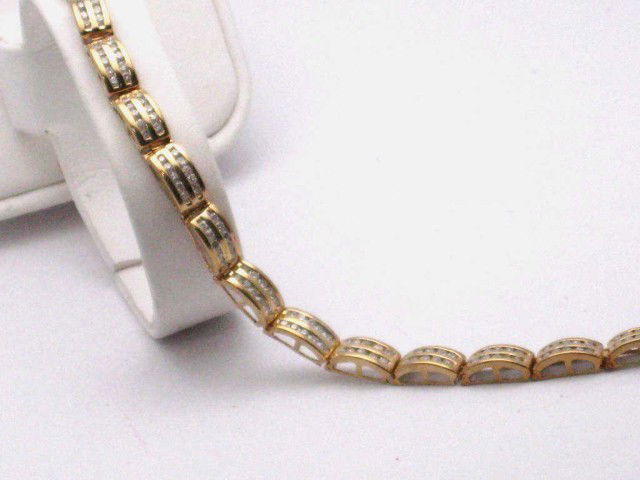 14kyg diamond bracelet 2ctw: 14kyg diamond bracelet 12.2gr with double row of channel set diamonds 2ctw 71/4" in length.