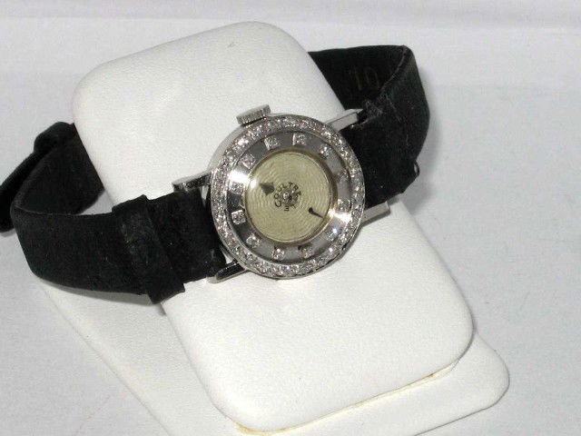 Vintage 14kwg LeCoultre diamond watch: Lady's vintage 14kwg LeCoultre diamond watch from the 40s with white dial,silver hands, diamond bezel and case,5/8" in diameter with black band (some wear). Just been reconditioned.