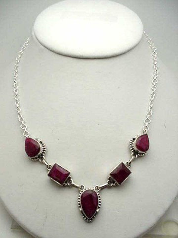Sterling silver ruby necklace 74cts: Sterling silver necklace 25 grams containing rectangular and pear shaped natural opaque rubies bezel set in a rolo link 17" necklace.