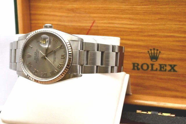 Man's stainless Rolex Datejust: Man's stainless Rolex Datejust with silver roman dial,quickset calendar, auto mechanical movement,water resistant and oyster band. Comes with box.
