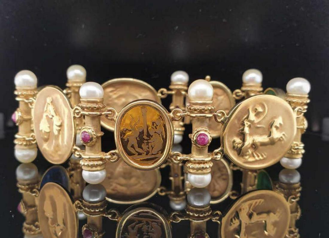 14kt yellow gold glass intaglio and pearl bracelet: Ladies 14kt yellow gold glass intaglio and pearl bracelet featuring bezel set green, blue and orange glass intaglios and gold cameo style links. Separated by bar links with 6mm pearls and cabochon cut