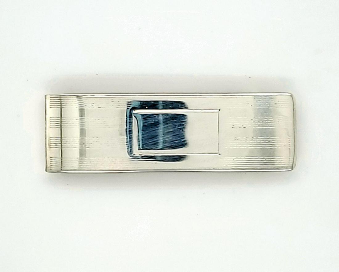 Sterling silver Tiffany & Co. money clip: Sterling silver Tiffany & Co. money clip featuring a in strip design and rectangular space for engraving. Length 2 1/4". Weight 19.2 grams