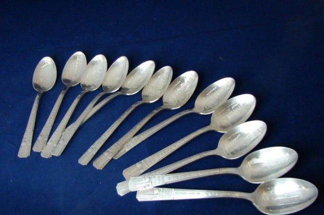 12 World's Fair New York 1939 Spoons: 12 World Fair New York 1939 Commemorative Spoons, each bearing the image of a different building from the fair.