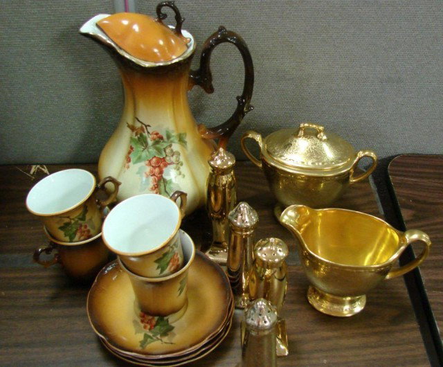 Vintage Hand Painted Chocolate Set: Vintage hand painted chocolate set consisting of a pot with lid and 4 cups and saucers. Some paint loss to pot - see photos, and a gold sugar & creamer set, 2 pr. salt & pepper shakers, no chips.
