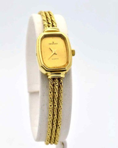 Lady's 14kyg Movado watch: Lady's 14kyg Movado watch 15.8gr with octagonal gold dial, quartz movement and 3 strand textured band with adjustable clasp.