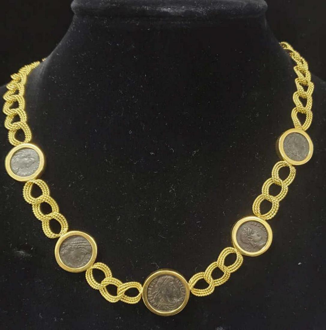 18kt yellow gold replica coin necklace: Ladies 18kt yellow gold coin necklace featuring twisted rope design links, accented with bezel set replica ancient coins. Length approx. 16". Gross weight 49.6 grams