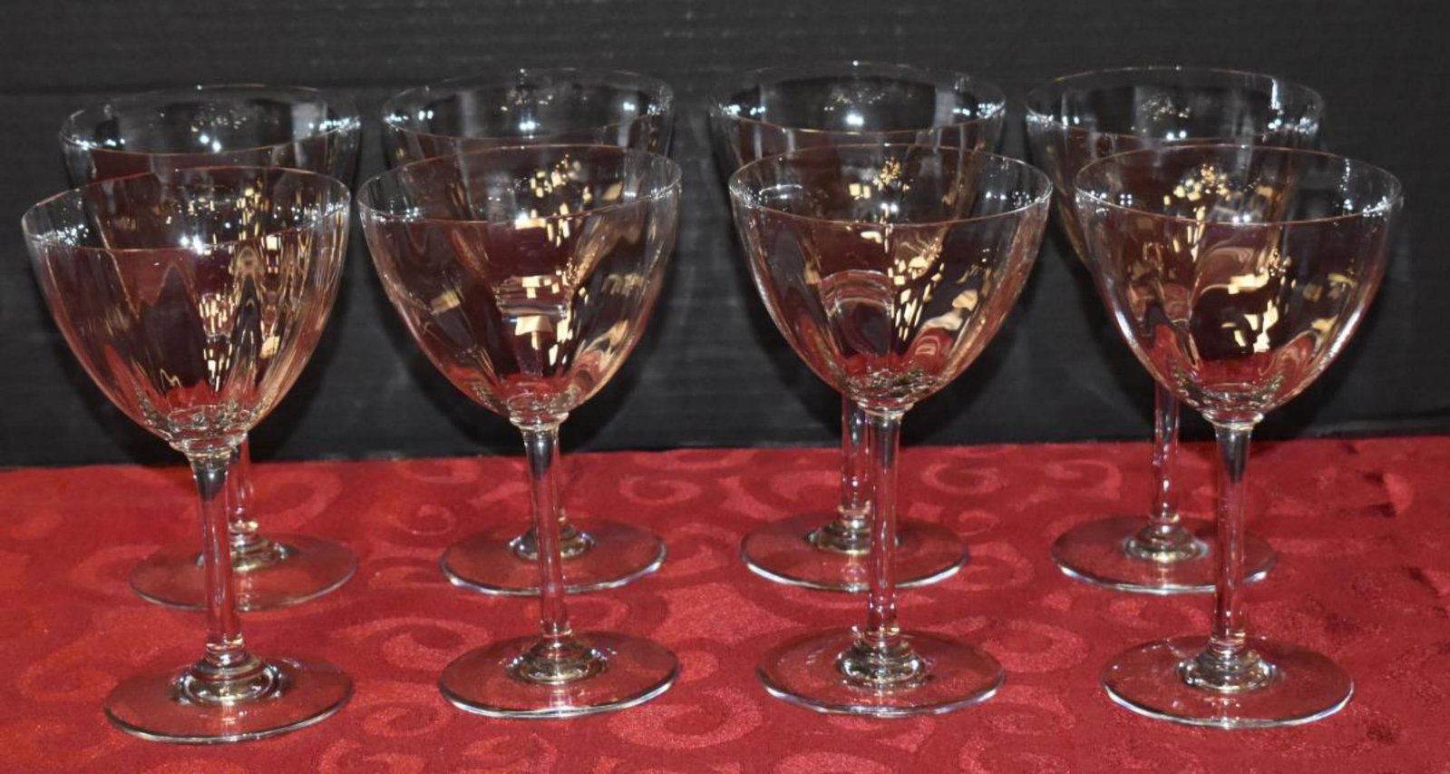 Baccarat Crystal Glass Stemware: Baccarat Crystal Glass Stemware. Total of 8 Glasses in the group. Glasses measure 6 1/4" in height. Baccarat stamp mark located on the bottom of the glass. 2 of the glasses have small chip/flea bite a