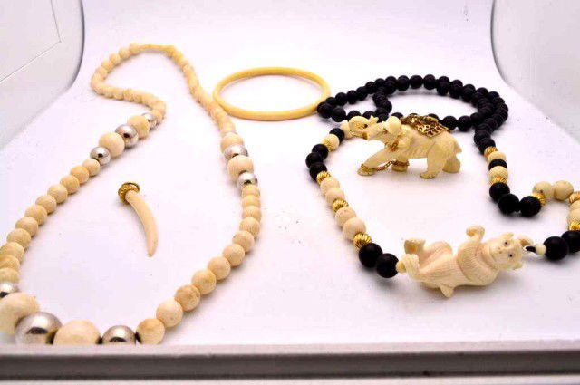 Suite of ivory & onyx bead jewelry: Suite of ivory jewelry including necklace with silver ball separators, onyx and ivory beads with gold ball separators and carved monkey, tusk pendant, bangle and carved elephant with diamonds.