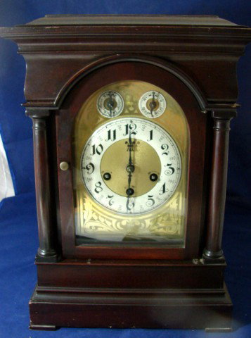 Antique Mahogany German Mantle Chiming Clock: Antique Mahogany German Mantle Chiming Clock, with key; working order; 16" x 11" x 8".