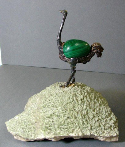 Bronze & malachite ostrich on geode: A bronze ostrich with a movable malachite egg in center and emerald eyes, 5 1/2" tall, standing on a heavy geode. Piece is 9" tall x 8" wide