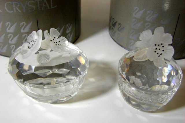 Swarovski oval & round Treasure Boxes: Two Swarovski Treasure Boxes with frosted flower on top, one oval, #7466 and one round #7464; no chips; original boxes.