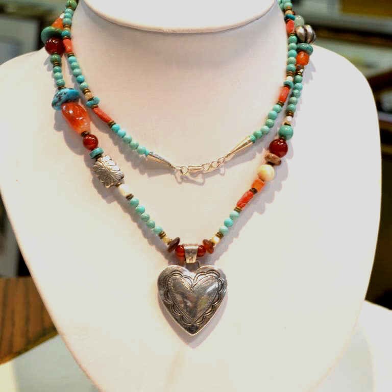 Indian turquoise necklace with sterling heart: Indian beaded necklace with turquoise, carnelian, agate and coral, 36" in length with sterling heart.