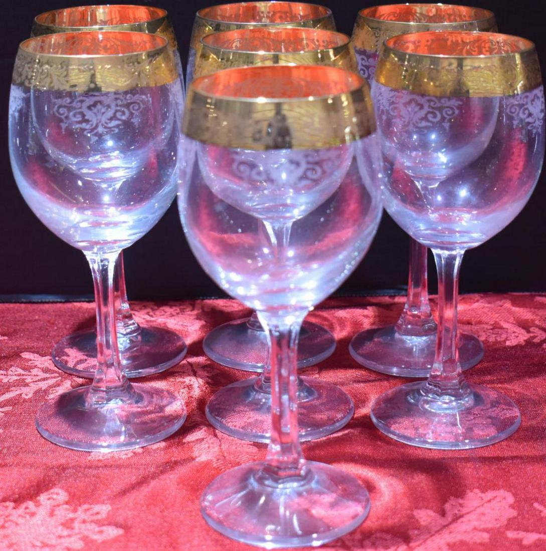 Group Of Gold Rimmed Red Wine Glass: Group Of Gold Rimmed Red Wine Glass. Total of 7 glasses in the group. Red wine glass stands 6 1/2" in height. 24kt gold rimmed with floral etch crystal red wine glasses by Cellini, Italy. Glasses are 