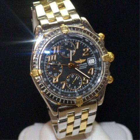 Man's Breitling Crosswind watch: Man's 18kyg/stainless Breitling Windrider watch with automatic movement, sapphire crystal, dive to 100m and 18k/stainless band. Scratches on band.