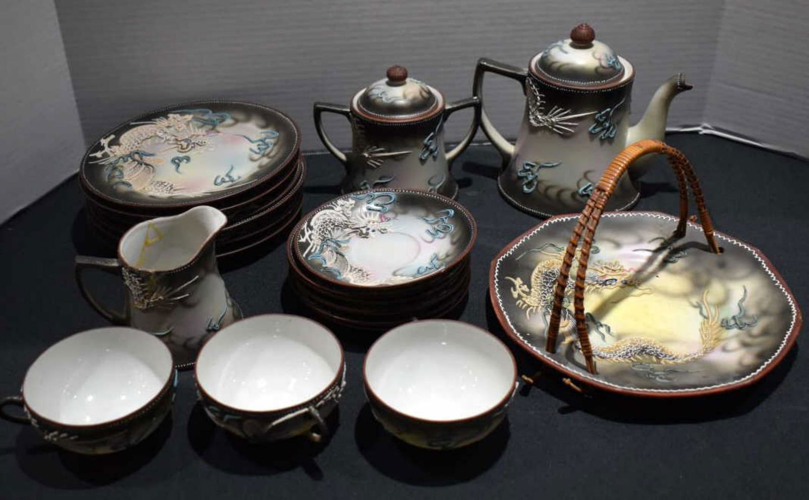 Vintage Japanese Dragon Ware Porcelain Tea Set: Vintage Japanese Dragon Ware Porcelain Tea Set. Consists Teapot 7" in height. Small chip on the spout part. Sugar with double handle 5 1/2" in height. Creamer 4" in height. Creamer has been repaired.