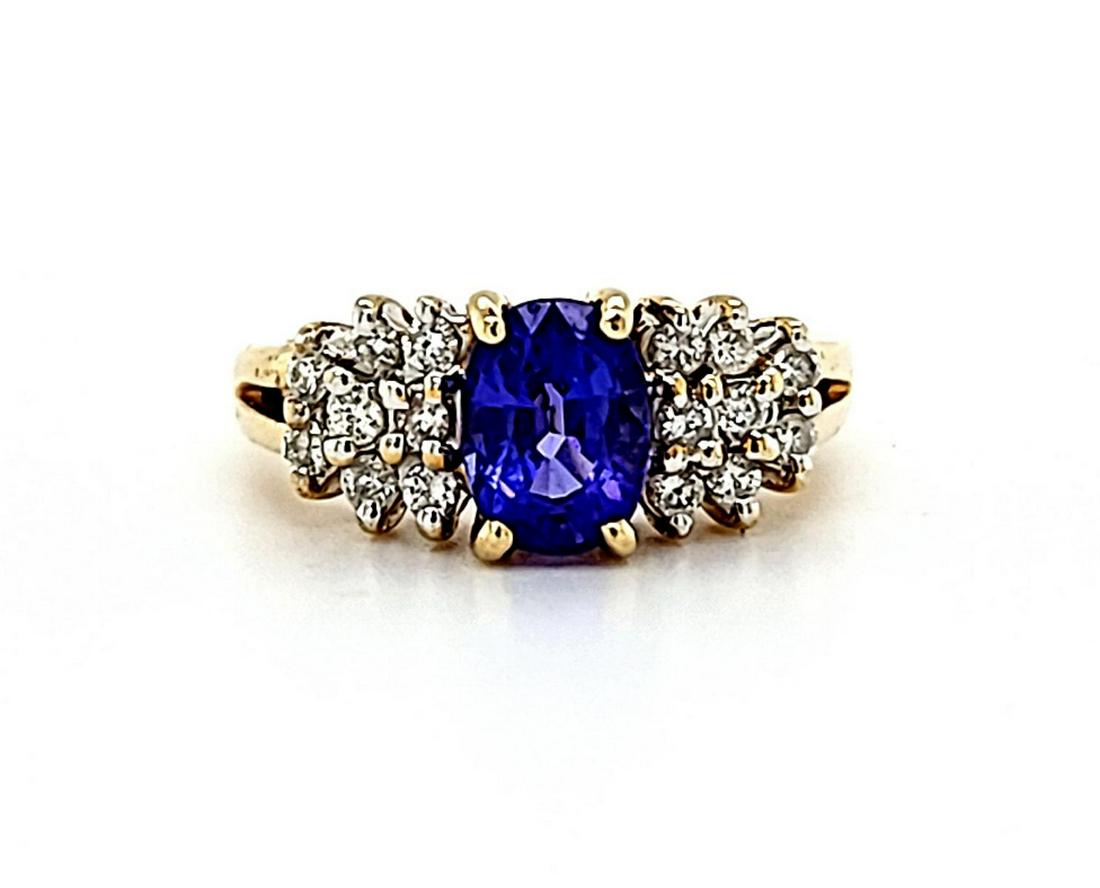 14kt yellow gold tanzanite and diamond ring: Ladies 14kt yellow gold tanzanite and diamond ring featuring a prong set oval cut tanzanite weighing approx. 1.06ct.. Accented with shoulders of prong et round brilliant cut diamonds weighing approx. 