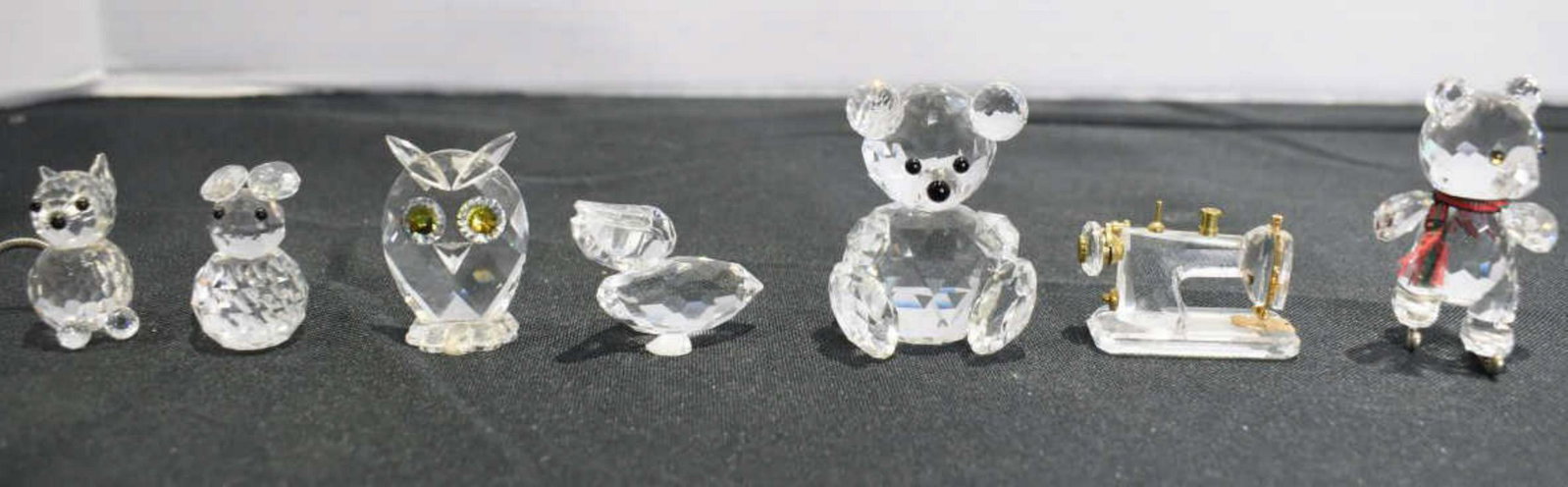 Group Of Swarovski Crystal Figurines: Group Of Swarovski Crystal Figurines. Sizes range from 1"-2" in height. Swarovski hallmark located on the bottom of each figurine. Consists of a pair of Bears. Owl. Rabbit. Pelican. Squirrel. Sewing m