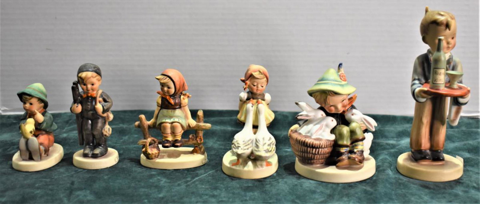 Group Of Hummel Figurines: Group Of Hummel Figurines. Total of 6 Hummel figurines in the group. Sizes range from 3"-6 1/2" in height. Consists of Chimney Sweep. Just Resting. Goose Girl. Singing Lessons. Playmates. Waiter. The 