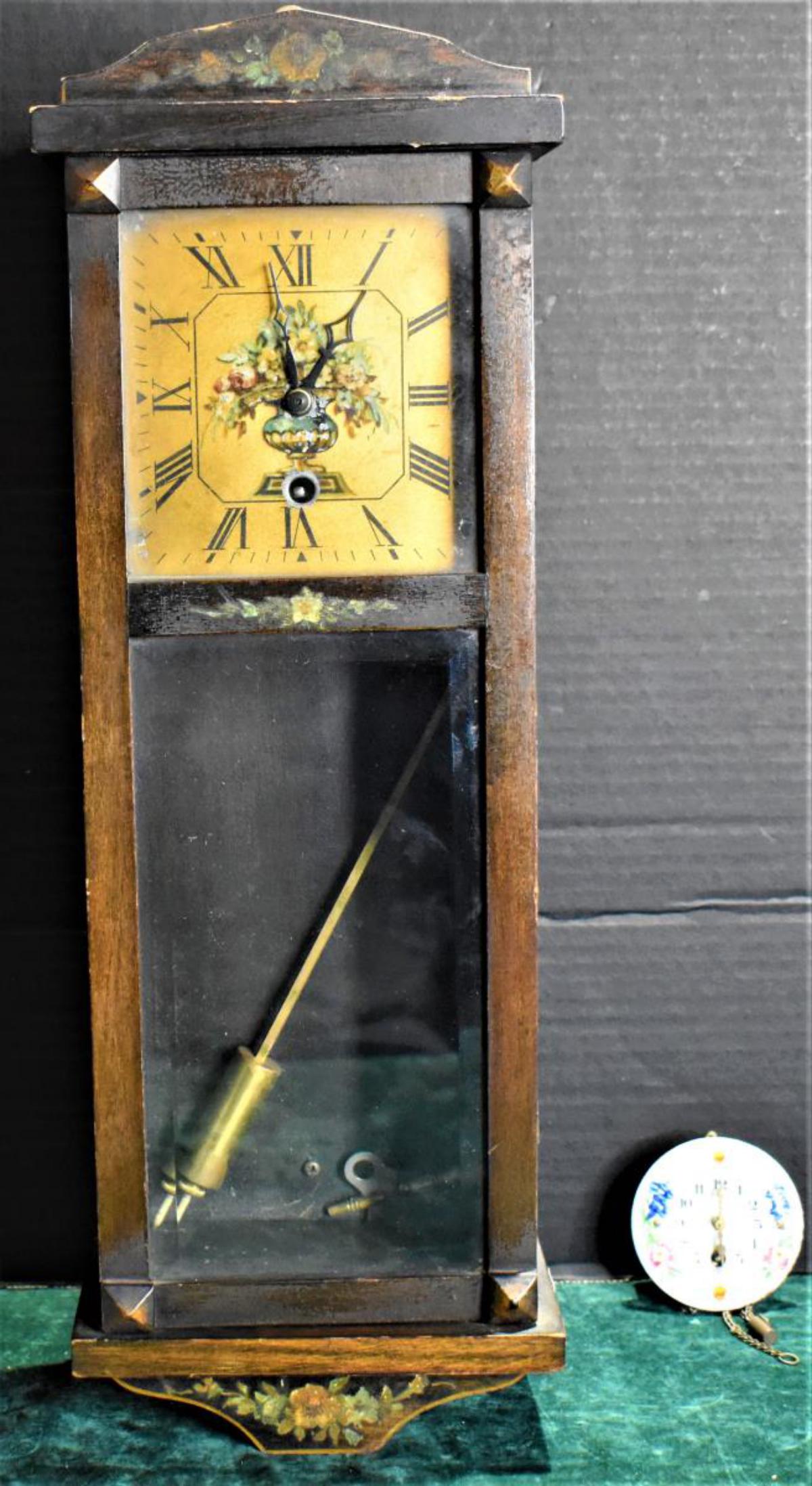 Antique European Wall Clock: Antique European Wall Clock. Measures 17" in height. Made of mahogany wood. Open pane pendulum door. Roman numeral dial. Clock come with key. Not sure if clock is in working condition. Also included i
