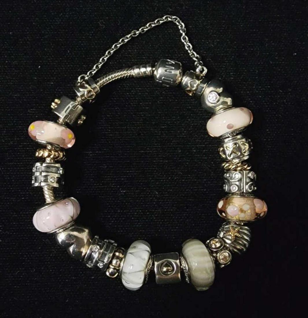 Sterling silver Pandora charm bracelet: Ladies sterling silver Pandora charm bracelet featuring sterling silver charms including an pink and white Murano glass, hearts and two tone patterned inks. Length 7". Gross weight 68.8 grams.