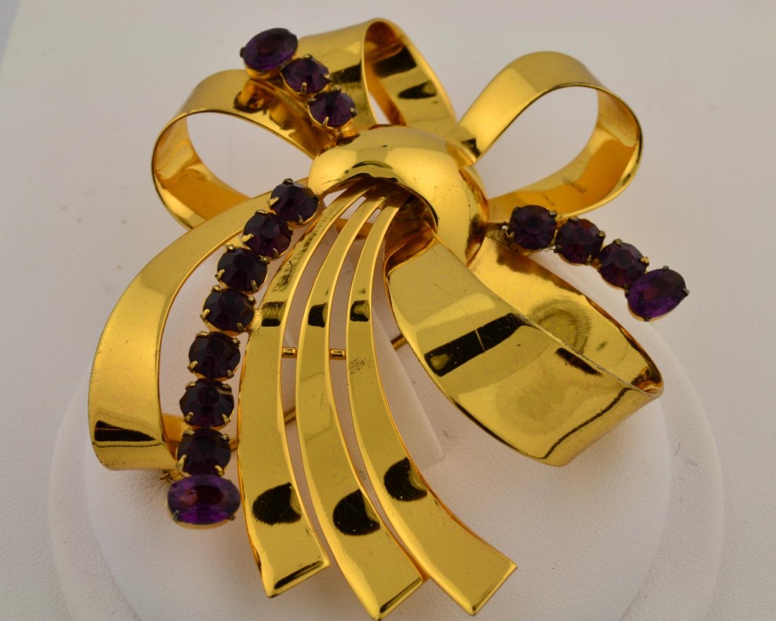 Sterling Gold Plated Bow Pin: Sterling Gold Plated Bow Pin with 15 purple stones snapped in. Length 3" x 2 3/4", 29.1gr