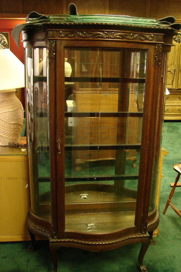 Antique Mahogany Curio Cabinet w/Glass Shelves: Antique Mahogany Curio Cabinet w/Glass Shelves, approx. 66" high x 38" wide; mirrored back. Shelves are glass curved to the shape of the cabinet, 1 shelf has 3 chips, ea. approx. 1/4" wide, and one ha