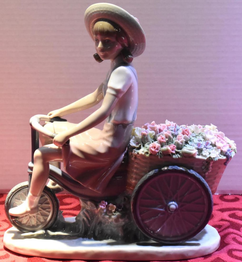 Lladro Porcelain Figurine: Lladro Porcelain Figurine. Measures 10 1/2" in height. Lladro "Girl With Flowers In Tow". Sculptor Francisco Catala. This is the first edition-1979. Created from 1979-1985.Retired porcelain piece. Lla