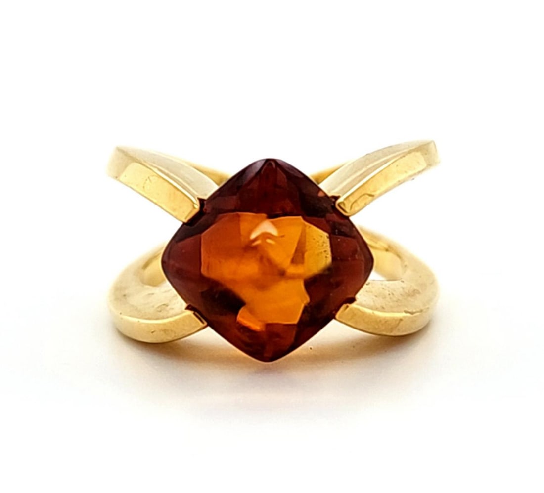 18kt yellow gold citrine and diamond ring: Ladies 18kt yellow gold citrine and diamond ring featuring a prong set pyramid cut citrine measuring approx. 12x12mm and mounted in split shank design and accented with flush set round brilliant cut d