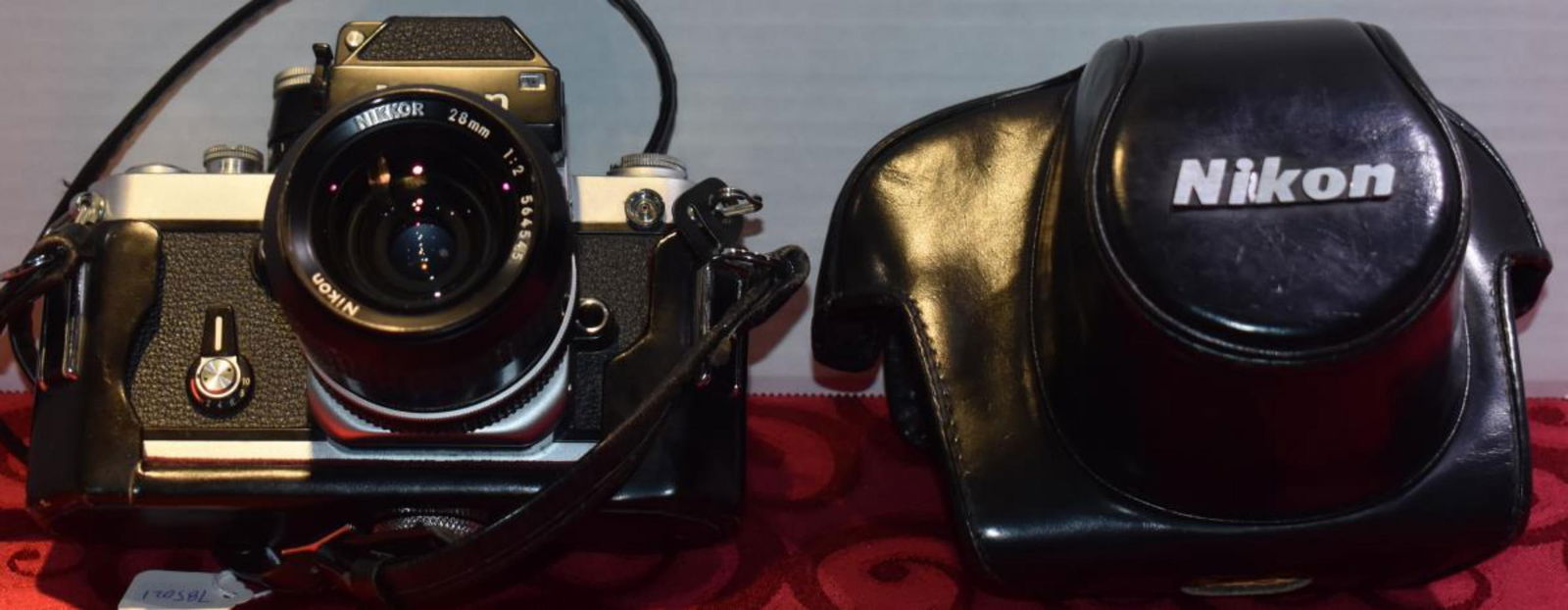 Nikon Camera With Leather Case: Nikon Camera With Leather Case. F2-7631140. Made in Japan. Shutter speeds 1-1/2000 seconds. Self timer mode. Removable fixed eye level pentaprism. 0.85x magnification & 94% coverage. Open aperture cen