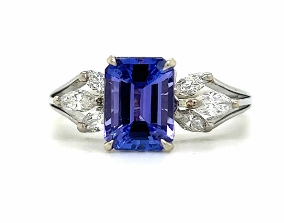 18kt white gold tanzanite and diamond ring: Ladies 18kt white gold tanzanite and diamond ring featuring a prong set rectangular step cut tanzanite weighing approx. 3.02ct. Accented with prong set marquise cut diamonds weighing approx. 0.34ct., 