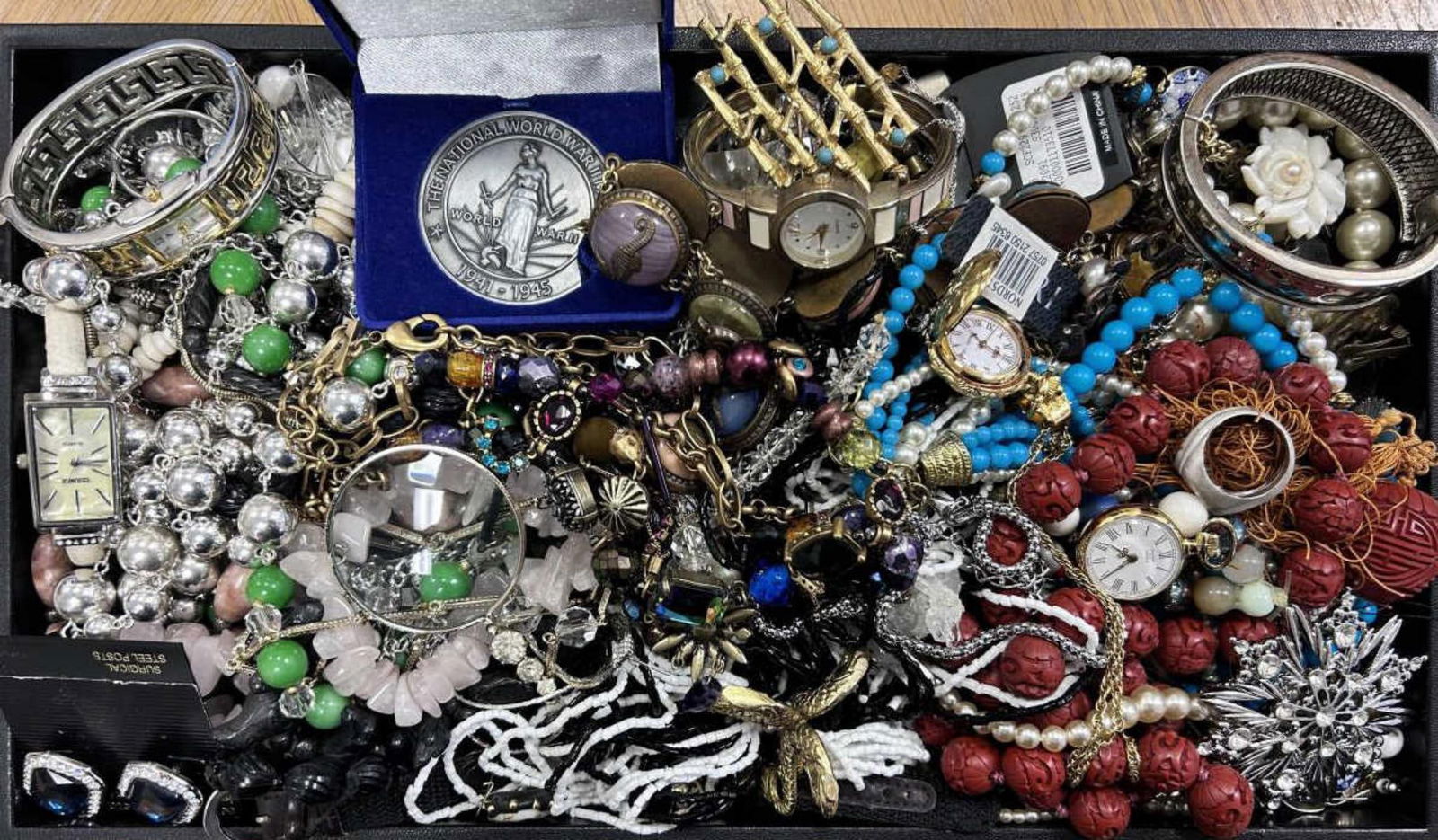 Large lot of costume jewelry: Large lot of costume jewelry including ladies fashion watches, beaded bracelets and necklaces, ladies watch pendants, large earrings and much more.