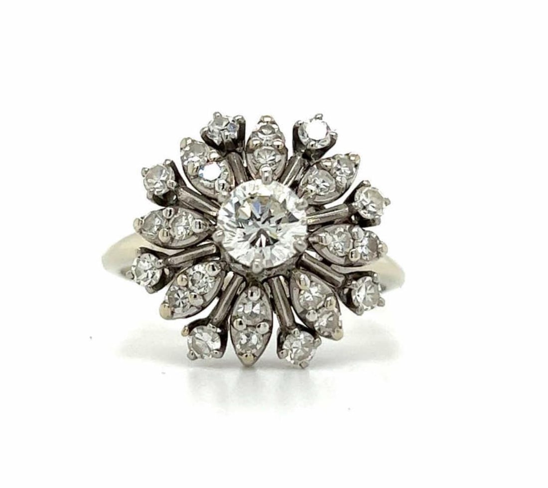 14kt white gold diamond snowflake ring: Ladies 14kt white gold diamond snowflake ring featuring a prong set round brilliant cut diamond center stone weighing approx. 0.54ct., Clarity SI2, Color H. Accented with a snowflake style frame detai
