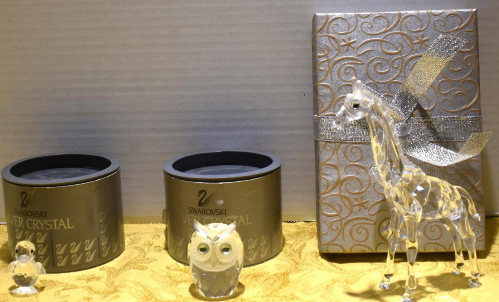 Trio Of Swarovski Crystal Figurines: Trio Of Swarovski Crystal Figurines. All come in original box. Consists of Swarovski duck 1 3/4" in height. Swarovski owl 1 1/2" in height. Swarovski giraffe 5" in height. All Swarovski crystal figuri
