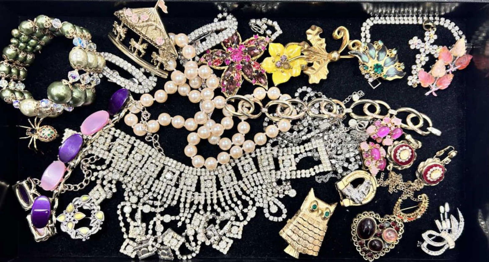 Large lot of costume jewelry: Large lot of costume jewelry featuring a pink rhinestone starfish brooch made by designer Weiss, pink clip on earrings made by Star, fancy link bracelets, lots of rhinestone necklaces, brooches, and e