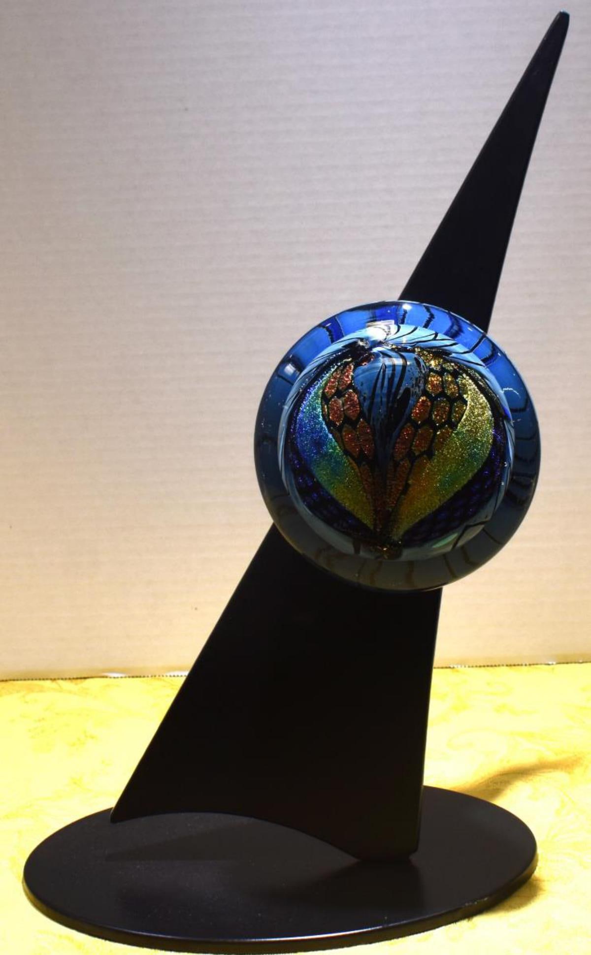 Art Glass Sculpture With Stand: Art Glass Sculpture With Stand. Measures 14 1/2" in height. Measures 9" in diameter. Minor chips on sculpture base. Dichroic multicolor Iridescent disc sculpture. Artist Karg 2009 signed on the back o