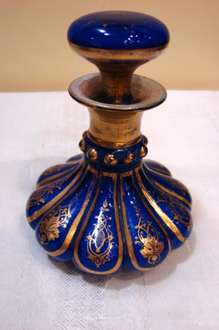 Antique Bavarian Cobalt Perfume Bottle: Antique Bavarian Cobalt Perfume Bottle with Gilt Filigree motif, dates from last half of 19th century. 5" tall; some wear to gilding, small chip on bottom of stopper - see photo.