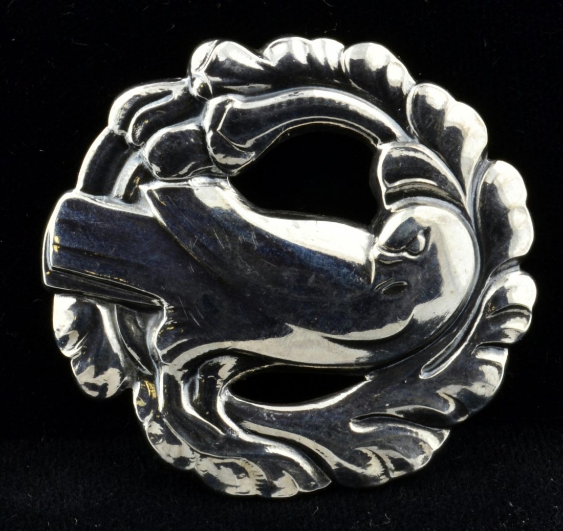 Sterling Dove Brooch by Georg Jensen: Sterling dove brooch by Georg Jensen circled in a wreath 11/2" in diameter stamped Sterling Denmark.