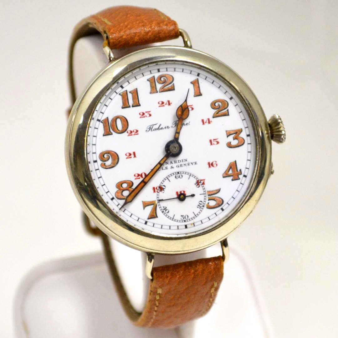 Vintage U. Nardin Tlabesr Watch: Man's vintage U. Nardin Loche & Geneve watch with white dial and gold numbers, gold painted hands,second hand, mechanical movement, leather band and good running condition.