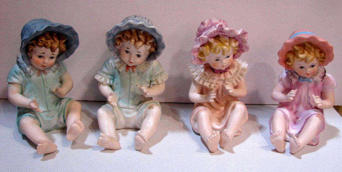 4 German Bisque Piano Babies - crossed sword mark: 4 German Bisque Piano Babies - two different crossed sword marks; do not know age. 6.5" tall; no chips.