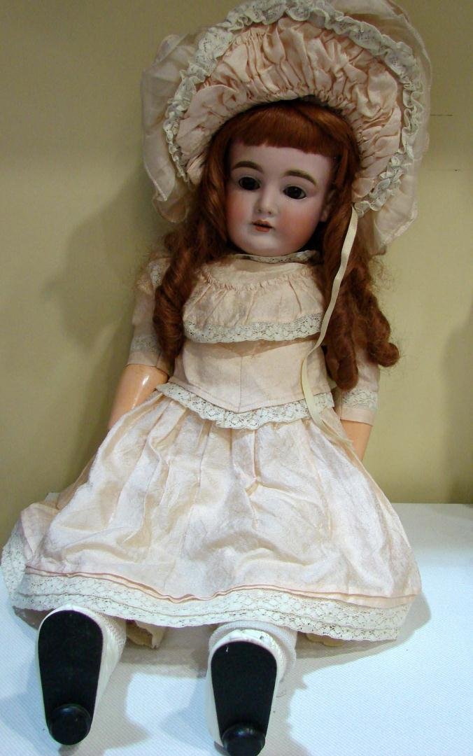 Antique German Doll 22": Antique German Doll 26" long, stamped on back Made in Germany 164; 22" tall, dress & hat look original. Wig is long heavy red hair in "sausage curls", marked mad in Philippines. Needs cleaning.