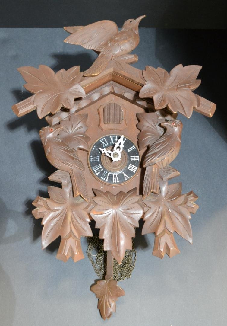 German Wooden Cuckoo Clock: German Wooden Cuckoo Clock with Birds and Leaves. Measures 11.5"x14.5". Not Tested.