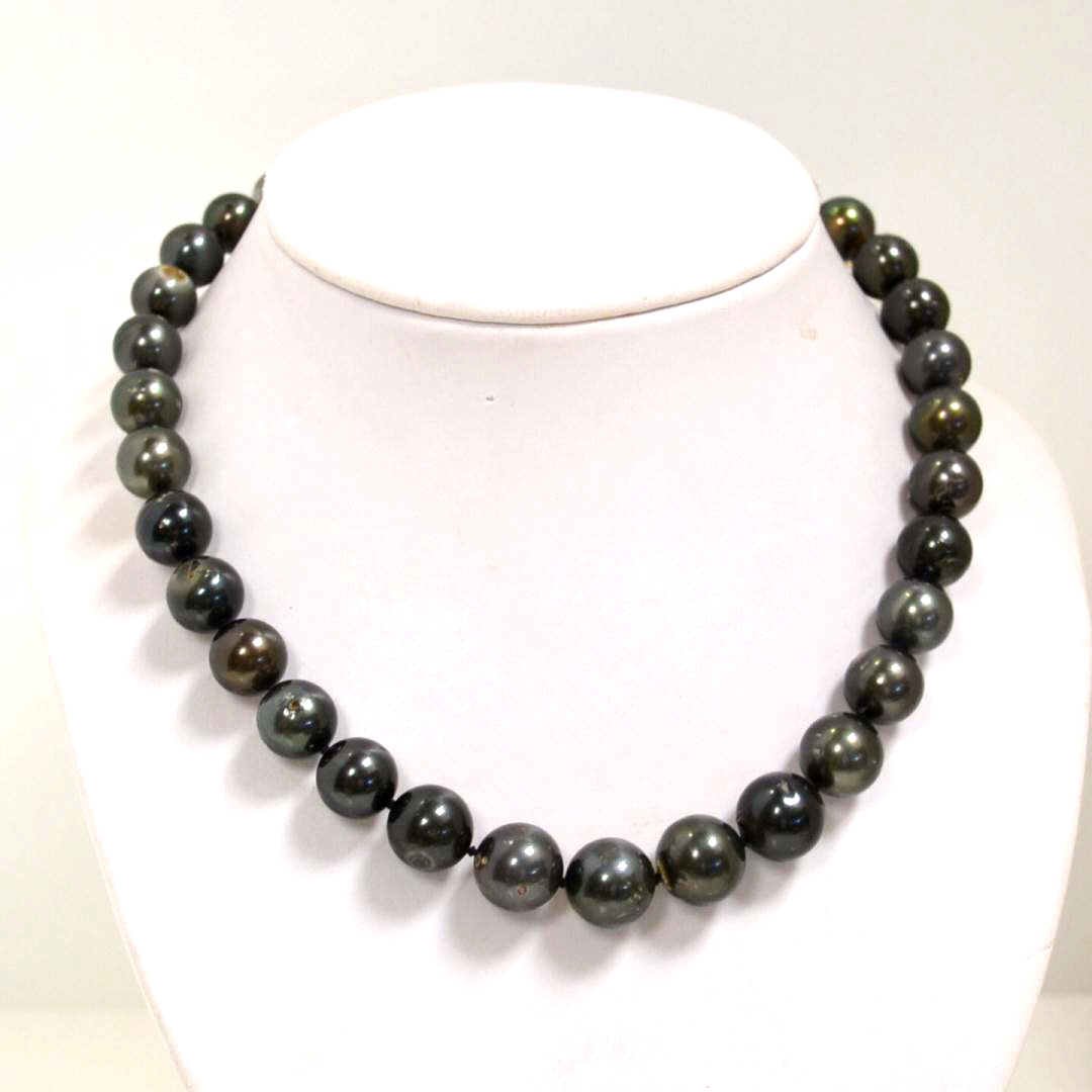 Tahitian South Seas Pearl Necklace: Lady's strand of Tahitian south seas graduated pearls size 10 to 14mm , single knotted with dark grayish green color, medium luster and very good shape. 18 strand with sterling ball clasp."