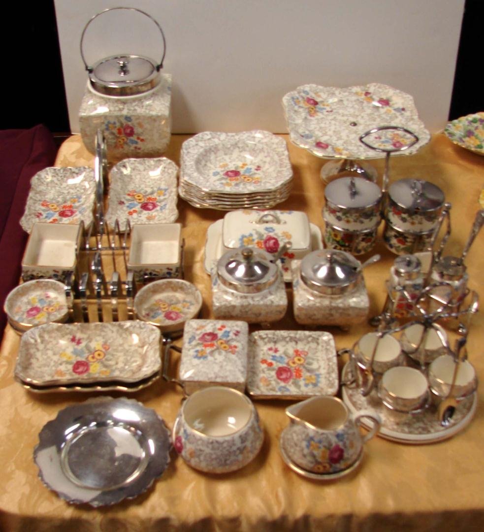 56 pcs. Lancaster & Sandland English Chintz China: 48 pcs. Lancaster & Sandland English Chintz China incl. Cov'd butter, sq. cake dish, 6 bowls, 3 silverplate 4 slot toast rack w/2 dishes, 3 pc. double relish, 4 egg cups, 9 pc. egg carousel, & 8 pcs. 