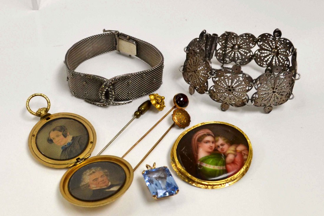 Lot of Vintage Jewelry: Lot of vintage jewelry including stick pins, gold tone locket, 2 silver bracelets, pin of mother and child and blue stone pendant in 14kyg. 4gm