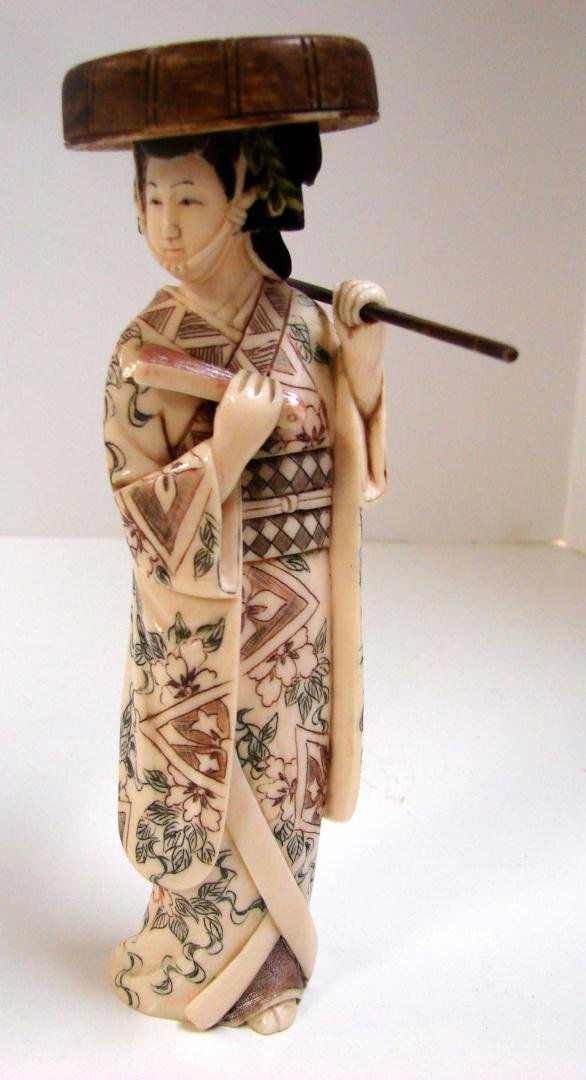 Polychromed Ivory Geisha Holding Staff w/Hat: Polychromed Ivory Geisha Holding Staff with Round Hat, signed, 7.25" tall.