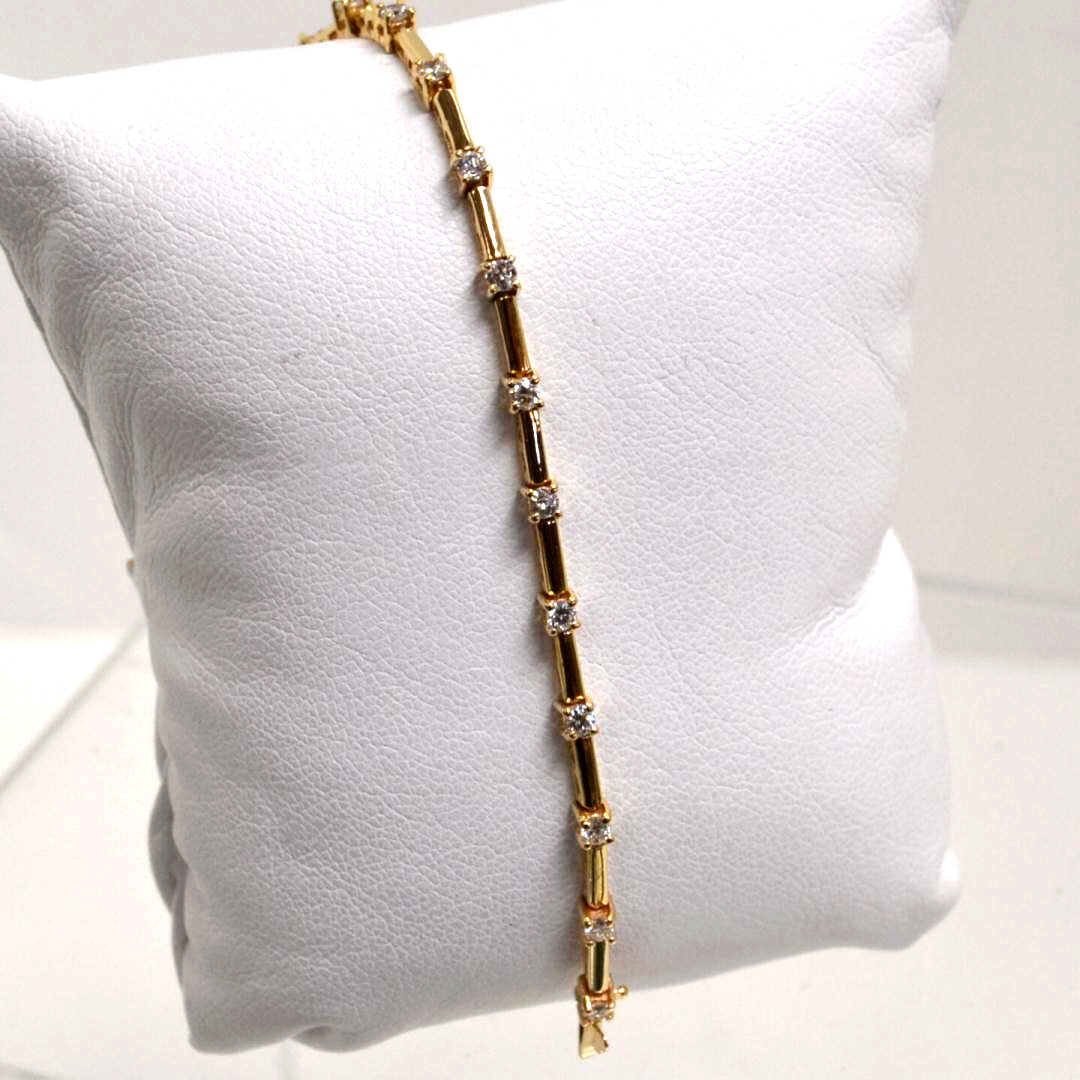 14kyg Diamond Bracelet 1ctw: 14kyg diamond bracelet with 20 prong set round diamonds weighing 1ctw clarity SI1-2 and H-I color alternating with polished bar and 7" in length. 6.3gm